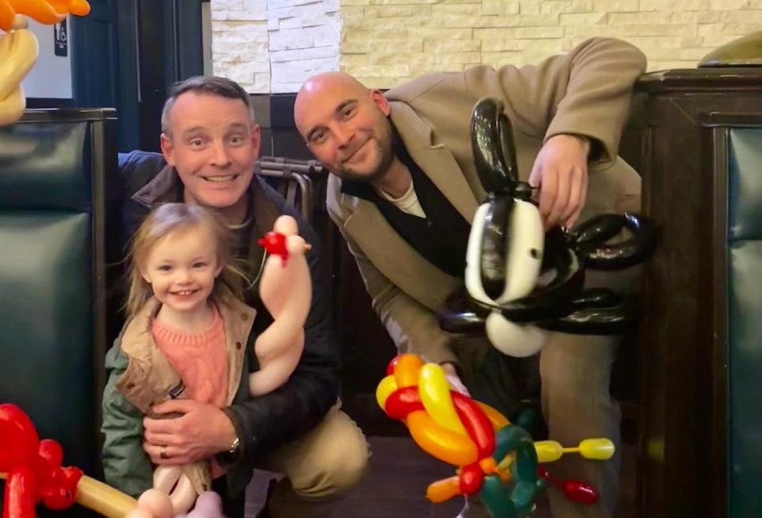 Damien and Myles with Damien's daughter at a family meal
